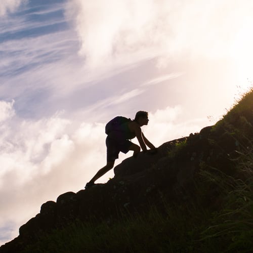 Man climbing up a mountain