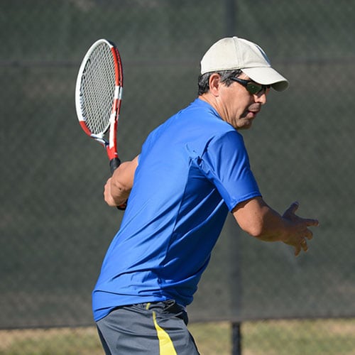 Middle-aged man playing tennis